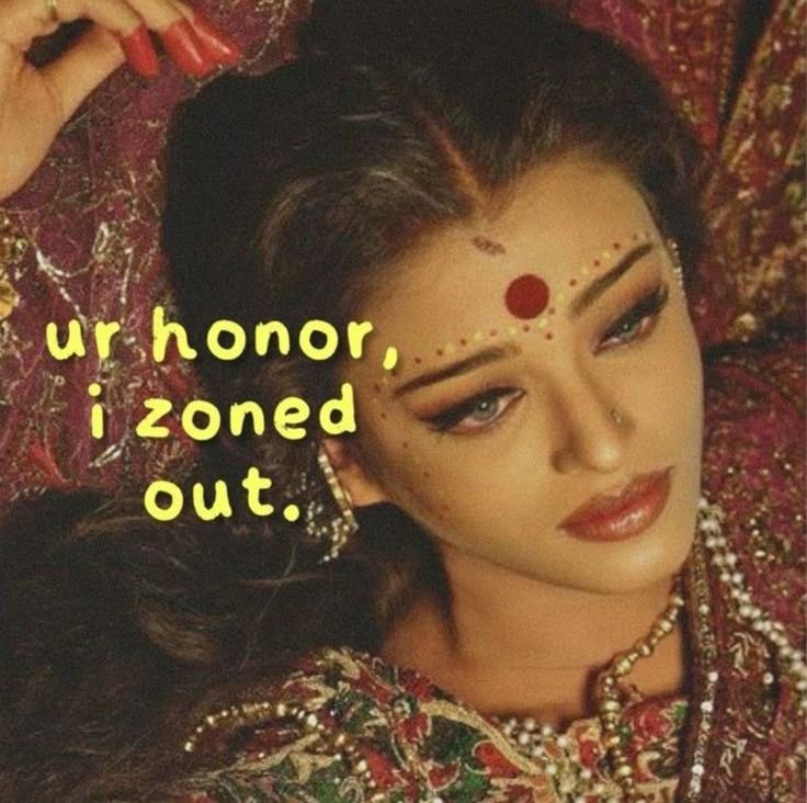 A close-up portrait of a woman adorned in traditional attire with elaborate makeup and jewelry, looking contemplative, accompanied by the text 'ur honor, i zoned out.'